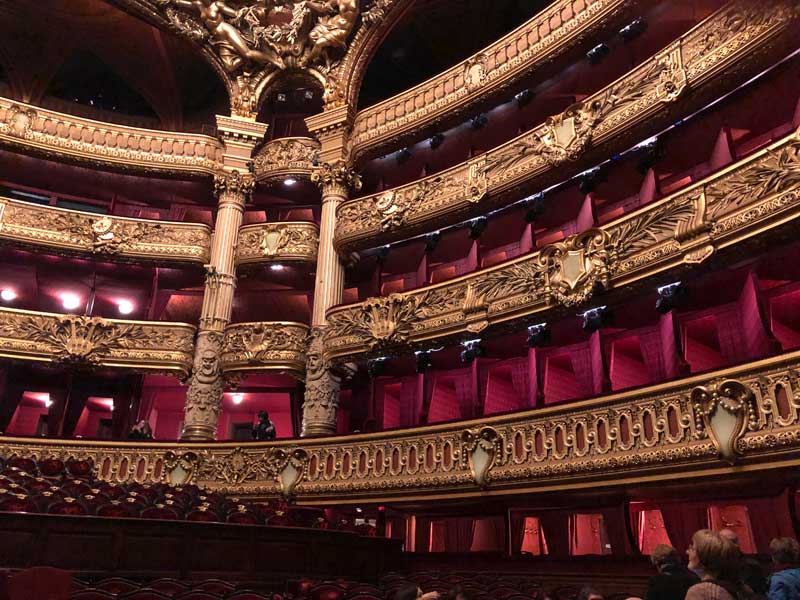 Gilded wood and red velvet seating in the balconies of the Paris Opera House